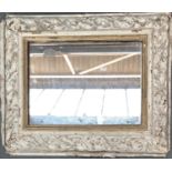 A 'gesso' framed mirror, white with some gilt, 54x65cm