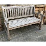 A slatted teak garden bench, bears 'Canterbury Collection' plaque, 139cmW