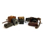 A mixed lot to include a Kodak box camera; Kodak Brownie Six-20 model D; together with one other;