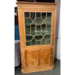 An astragal glazed pine standing corner cupboard, green painted interior, with shaped shelves,