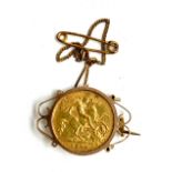 A 1910 gold half sovereign coin having George and the dragon design in a 9ct gold surround, gross