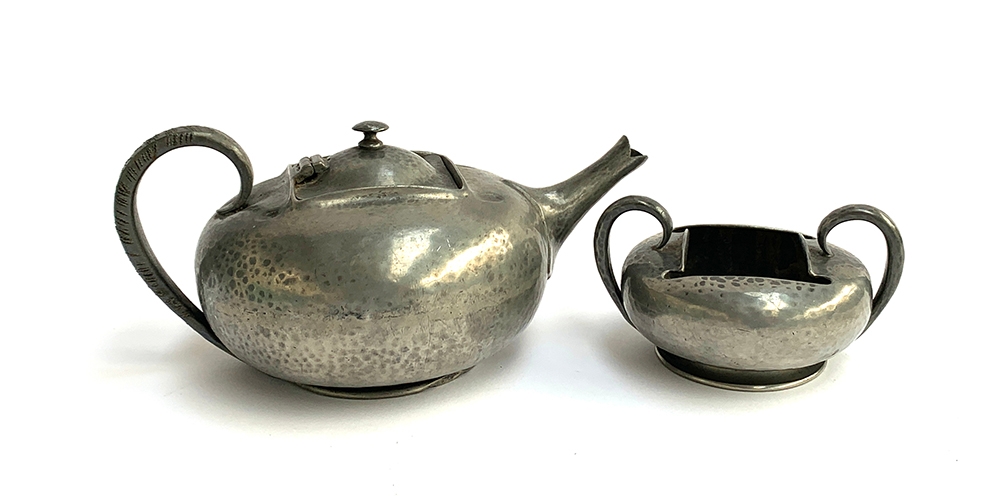 A Liberty & Co. Tudric pewter teapot, marked 0966, together with matching twin handled sugar bowl,