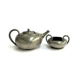A Liberty & Co. Tudric pewter teapot, marked 0966, together with matching twin handled sugar bowl,