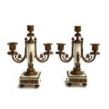 A pair of marble and gilt metal two arm candlesticks