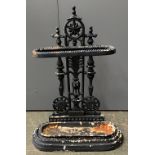 A cast iron umbrella stand, with drip tray, in the Aesthetic Movement style