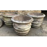 Three very large composite stone planters, decorated with swags, each 77x59cmH