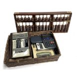 A quantity of calculators, an abacus and an addiator calculating machine
