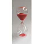 A large glass sand timer, containing red sand, with hairline crack, 37cmH
