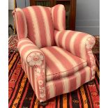 A heavy wingback armchair, serpentine front, upholstered in a striped fabric