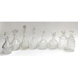 A collection of eight cut glass decanters and stoppers, the tallest 31cmH