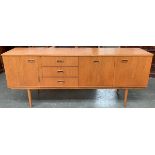 A mid century oak sideboard, three drawers and three cupboard doors, 182x43x74cm