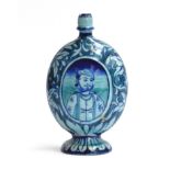 An Iznik bottle vase of compressed oval form, turquoise and blue glaze, with the central panel of