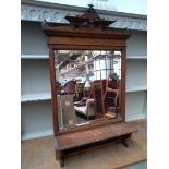 An oak framed mirror with shaped top and bevelled glass plate, small blackboard beneath, 96x53cm