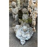 Two composite stone garden figures, together with a composite stone planter in the form of cherubs