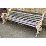A heavy white painted garden bench with cast iron supports, 190cmW