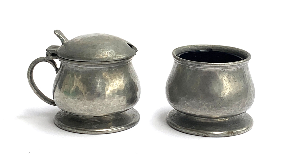 A Liberty & Co. Tudric pewter salt with blue glass liner, marked to base 01078, and lidded