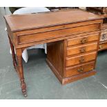 An unusual late 19th/early 20th century kneehole desk by Walter F Gibbs, hinged top over four