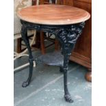 A cast iron circular garden table, with undershelf and paw feet, the circular wooden top 63cmW