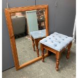 A modern pine framed wall mirror, 73x104cm; together with an upholstered footstool