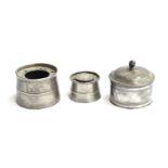 An early 19th century pewter lidded canister, 12cm diameter; together with a pewter capstan inkwell,