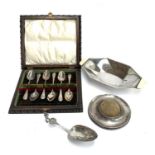 A set of six King's Pattern silver coffee spoons, in a carved walnut case; a silver pin cushion; Art