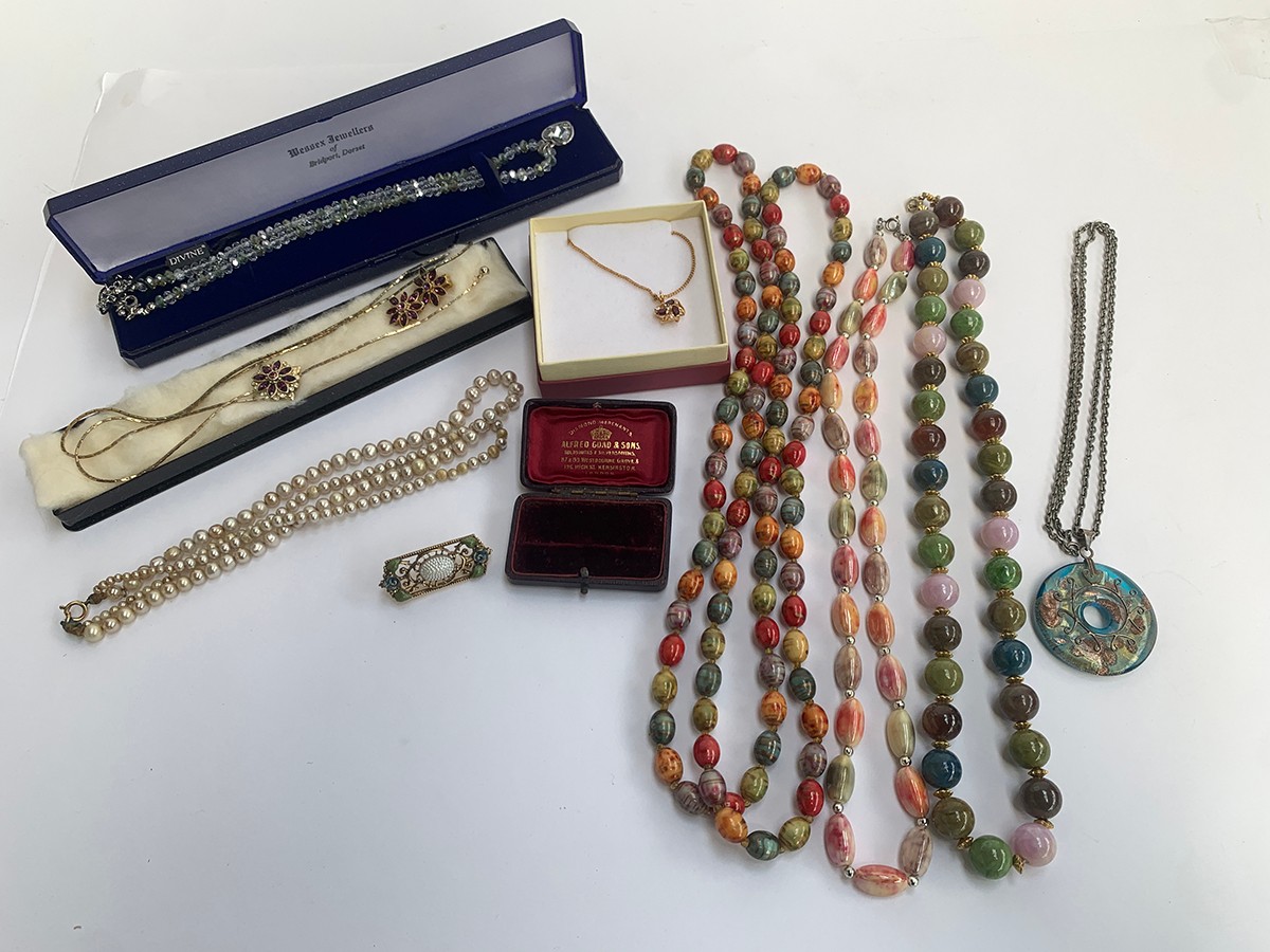 A mixed lot of costume jewellery to include necklaces, one with 925 silver pendant bail; together