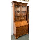 An astragal glazed bureau bookcase, fall front over two short drawers and two cupboard doors, on