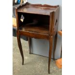A small continental nightstand, three quarter gallery top, over an open cupboard with shallow side
