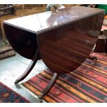 An oval drop leaf dining table, on swept legs, and brass paw feet and casters, 122cmW 74cmH