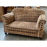 A two seater sofa, approx. 135cmW; together with a number of loose cushions
