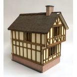 A mock Tudor style dolls house, containing a quantity of furniture and accessories, 53x38x53cm