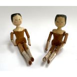 Two 19th century Dutch style wooden peg dolls, with painted head and jointed limbs, each approx.