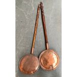 Two long handled copper bed warming pans