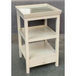 An OKA bedside cabinet, galleried glass inset top, over two shelves and drawer, 43x43x71cm