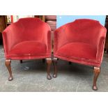 Two small red velvet upholstered tub chairs, on cabriole legs