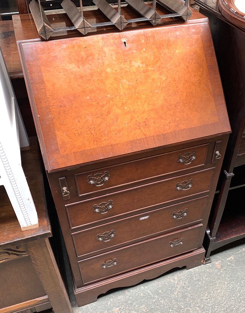 A small burr walnut veneer bureau, fall front over four drawers, 53.5cmW