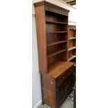 A narrow oak bookcase, with drawers and cupboard below, 91cmW