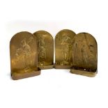 A set of four wall hanging brass plaque candle holders, each chased with figures, approx. 35cmH