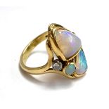 An 18ct yellow gold ring set with freeform opals, and two brilliant cut diamonds (approx. 0.