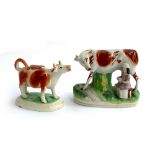 A Staffordshire cow creamer, 14cmH; together with a Staffordshire figure of a milkmaid and cow,