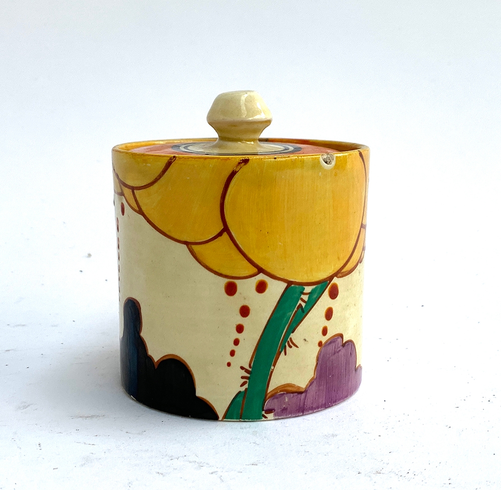 A Clarice Cliff 'Fantasque' jam pot, 9.5cmH