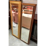 A gilt framed long mirror with bevelled glass, 137x45.5cm; together with one other similar