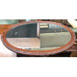 An oval wall mirror, in a bead moulded mahogany frame, 73x52.5cm