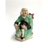 A 19th century Staffordshire Toby jug, modelled as George Whitfield the night watchman seated
