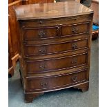 A small 20th century bachelor's bowfronted chest, with slide over four drawers on bracket feet,