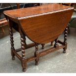 An oak oval gateleg table, on barleytwist supports, 90x44x73cmH