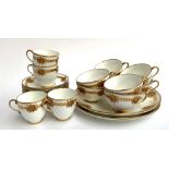 A part tea service heightened in gilt with floral decoration, comprising eight teacups, four