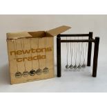 A vintage boxed Newton's Cradle by Scientific Demonstrations Ltd