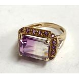 A 9ct gold dress ring set with purple stones, gross weight 5g