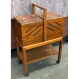 An oak metamorphic sewing box on casters, 50cmW